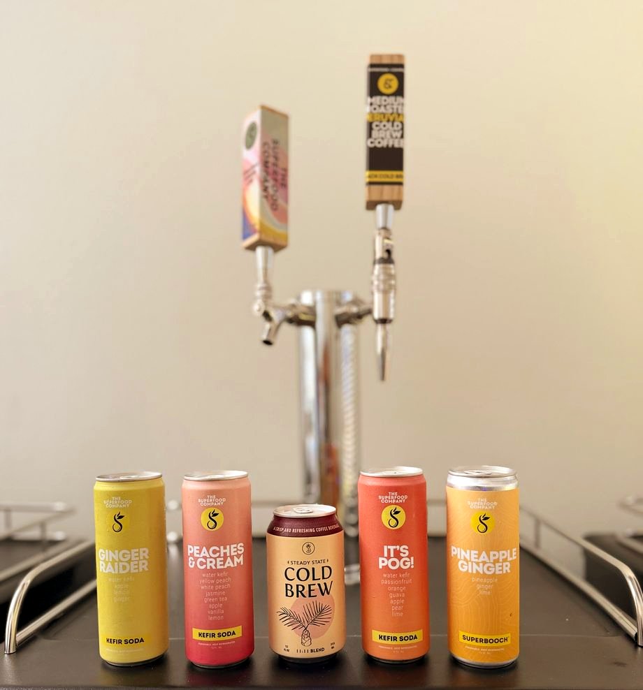 A Perpetual tap tower with a lineup of colorful cold-brew, kombucha, and kefir-soda cans